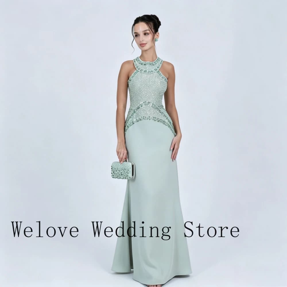 Green Formal Evening Dress with High Halter Neck Sleeveless Design Fully Beaded Bodice Sequined Waist Detail and Form-Fitting